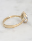 Gold ring with a diamond on a white background