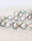 Pearl necklace with gold accents on a light background