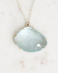 Blue topaz necklace laying on marble