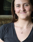 Woman wearing pink stone necklace