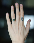 Large stone ring with branchy prongs on hand with tattoo