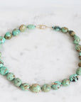 Turquoise beaded necklace on a marble surface