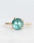Green stone ring with inclusions and prongs