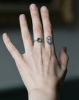 Hand wearing green stone ring