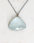 Blue topaz necklace with oxidized chain and setting. Gold prongs