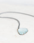 Blue topaz necklace on marble background