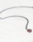 Purple spinel necklace on marble background