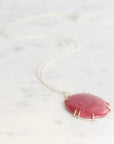 Necklace with a pink pendant on a white background