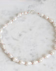 Pearl necklace on a marble surface