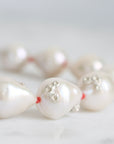 Pearl necklace with a close-up of a pearl on a light background