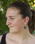Woman wearing bright blue lapis earrings