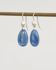 Pair of blue teardrop earrings on a white background