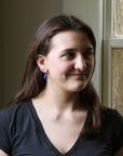 Woman wearing a black shirt with a window in the background