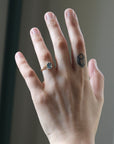 Hand with a ring on a blurred background