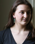 Woman wearing a black top with a neutral background