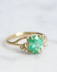 Bright green stone ring with diamonds and branchy prongs