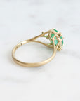 Bright green stone ring with diamonds and branchy prongs