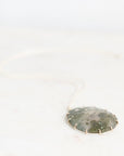 Moss agate pendant with gold prongs