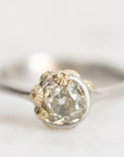 Diamond ring set in platinum bezel with gold barnacles clinging
