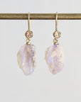 Pale colored fossilized opals suspended from gold ear wires with rose detailing.