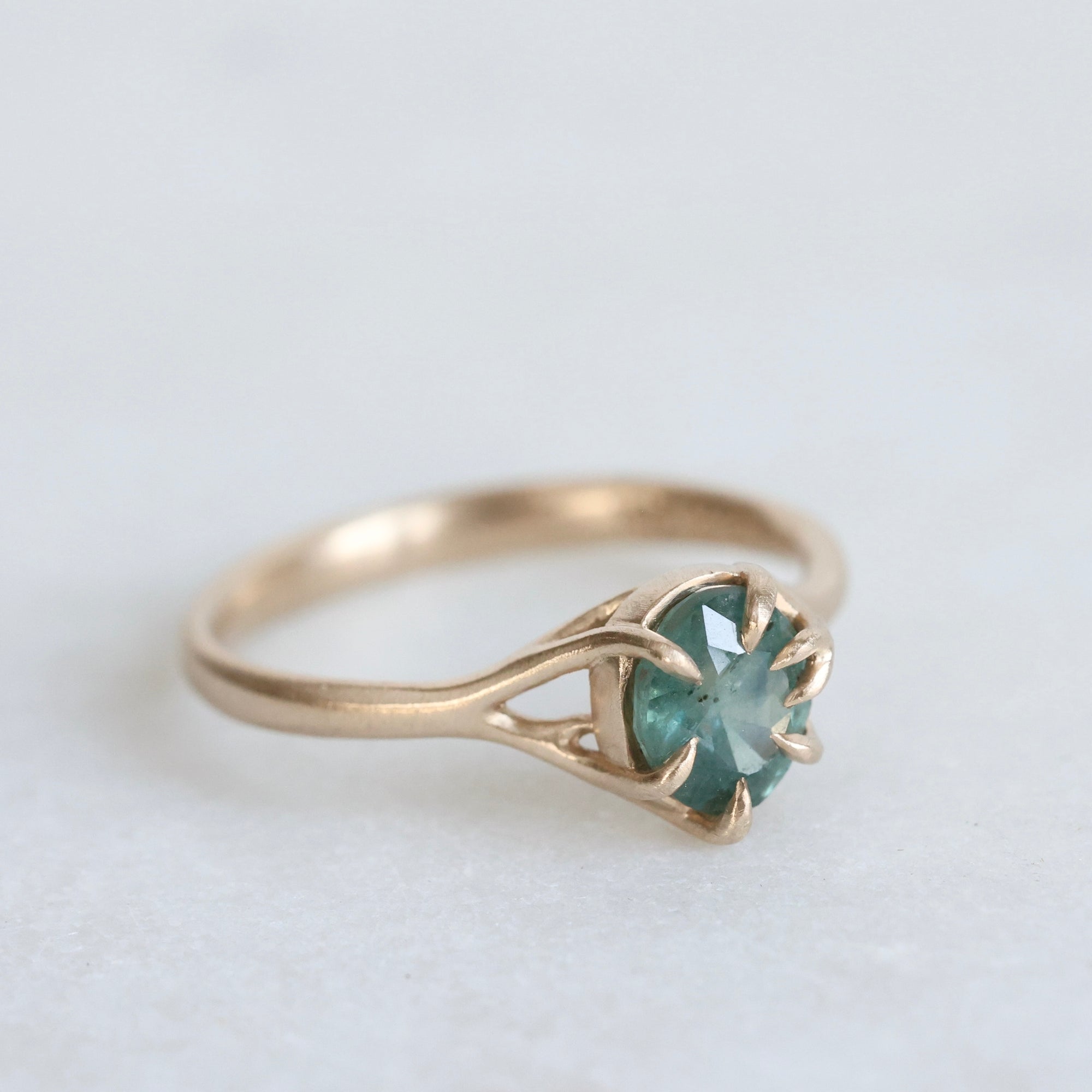 Green/blue sapphire in gold branchy setting