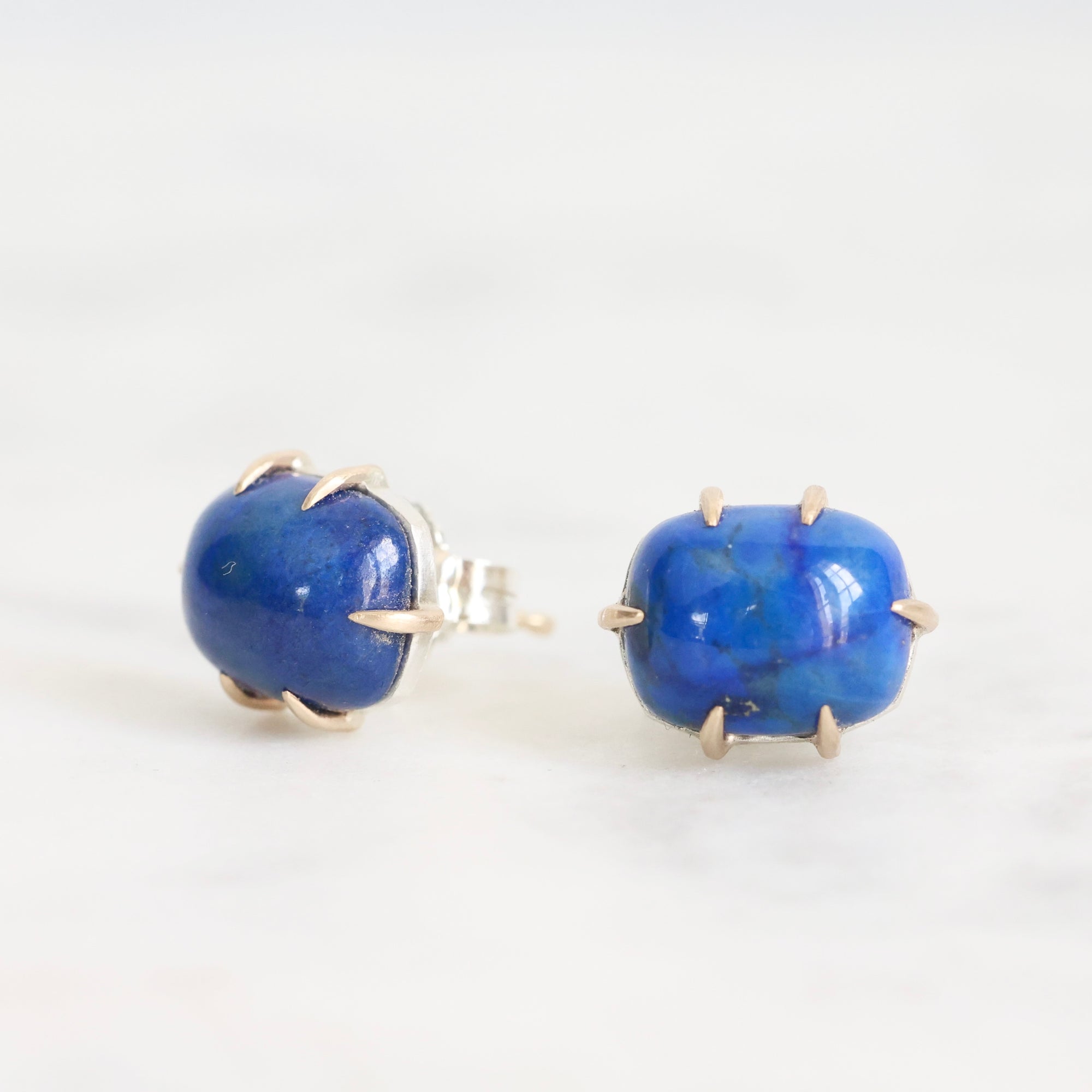 Pair of blue stone earrings on a white background