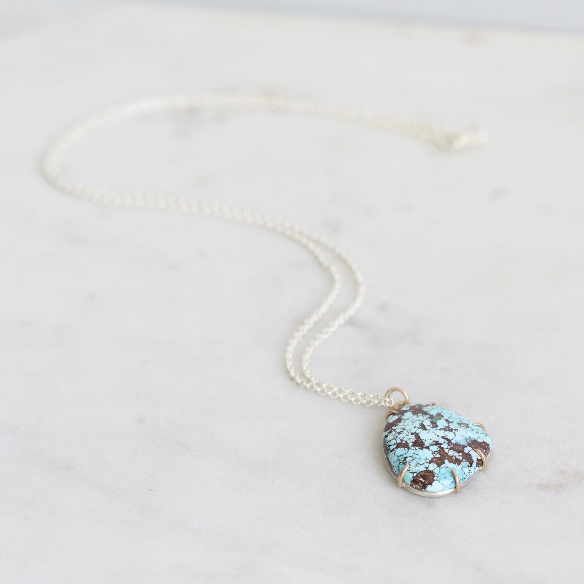 Turquoise stone necklace on a white background