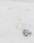 Turquoise stone necklace on a white background