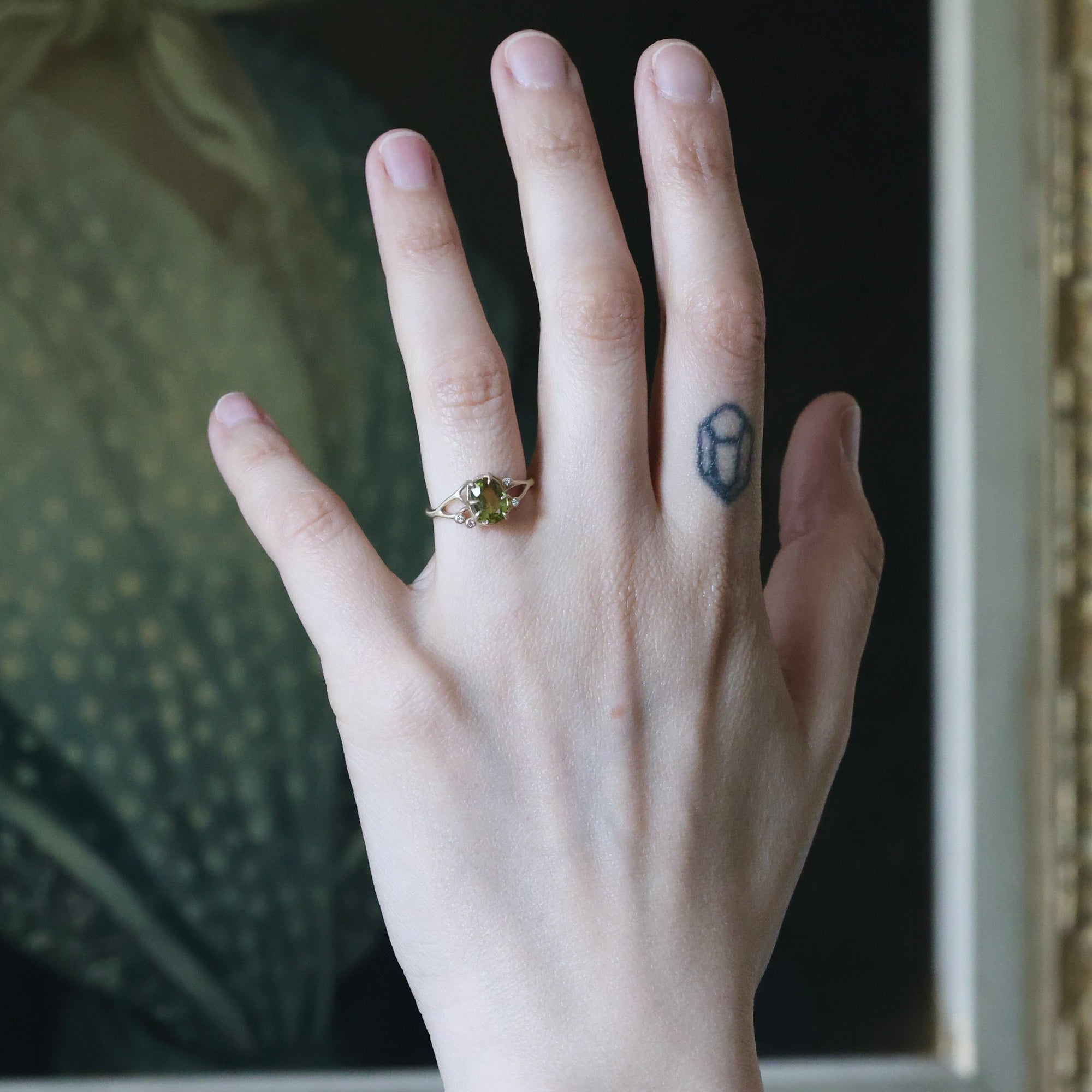 Hand with a ring on a blurred background