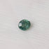 Green gemstone on a white fabric background