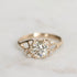Gold ring with a diamond on a light gray background