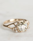 Gold ring with a diamond on a light gray background