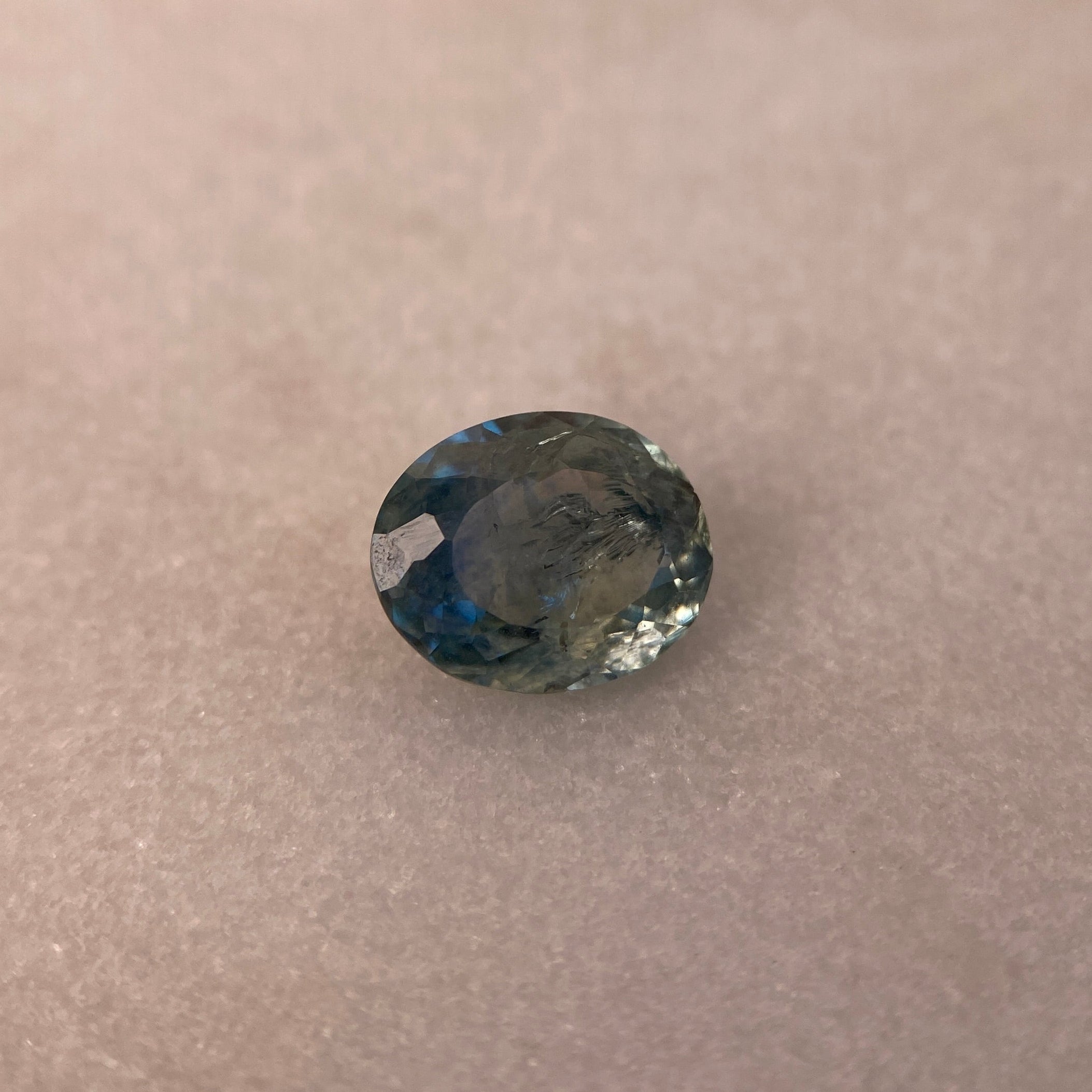 Blue gemstone on a beige background
