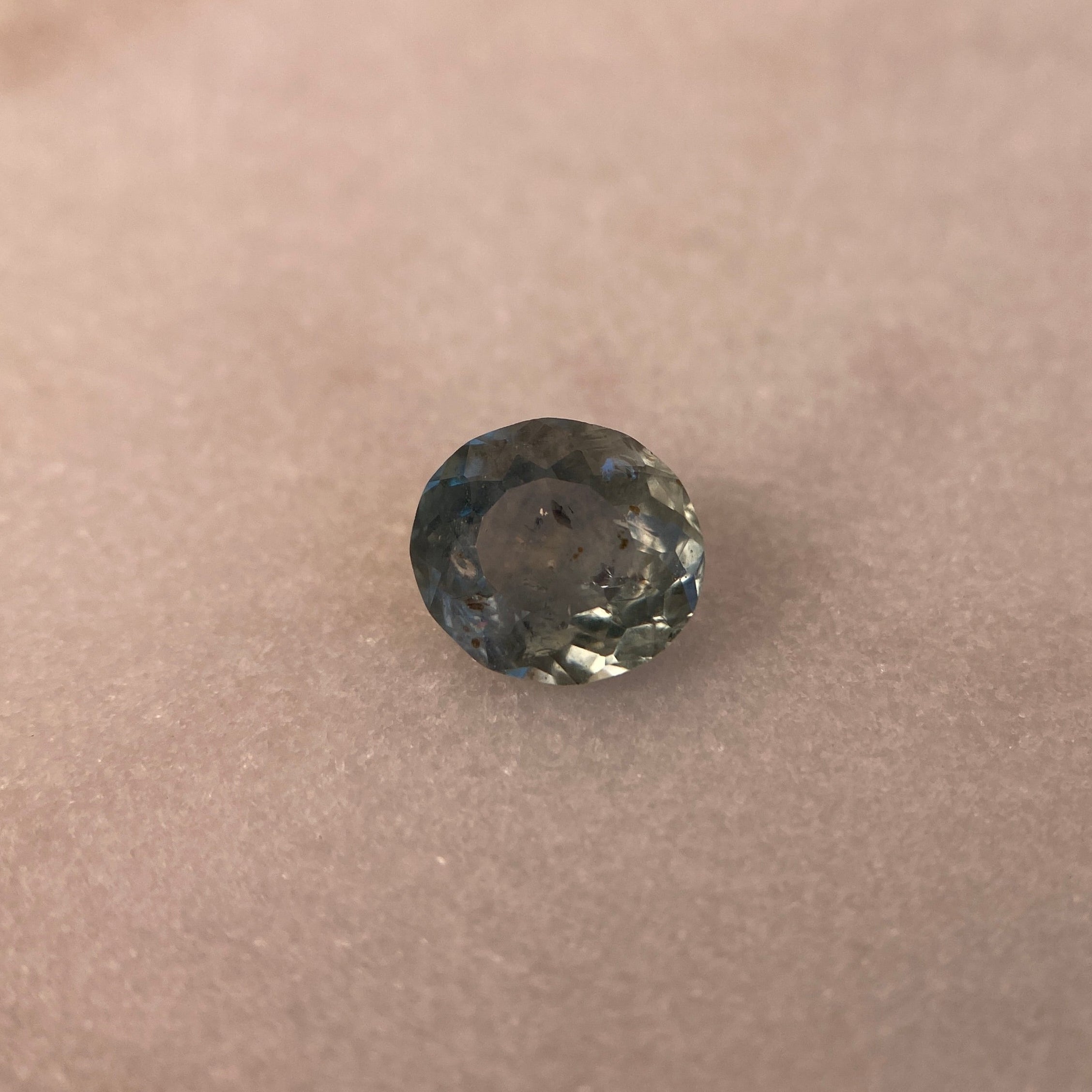 Round gemstone on a beige background