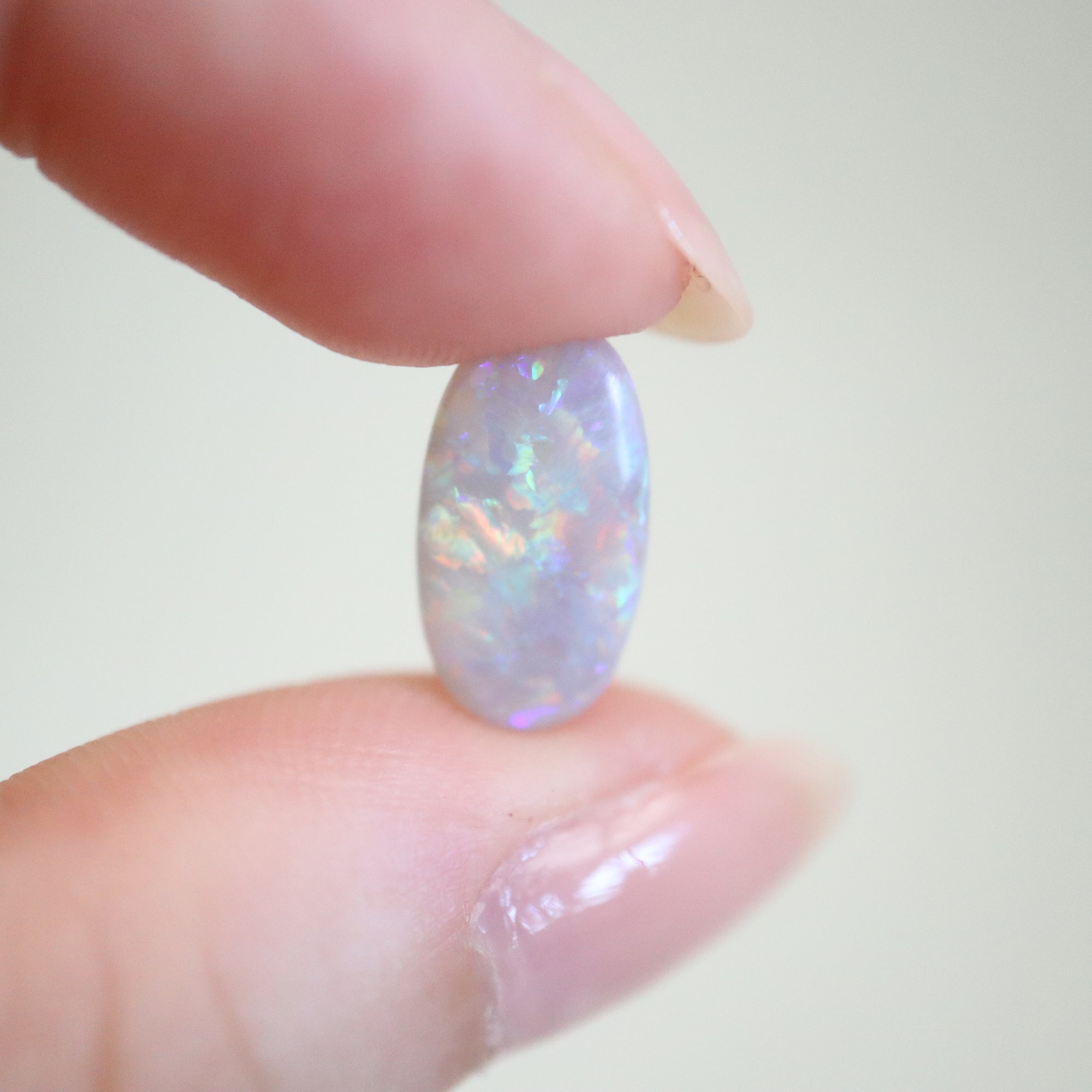 1.55ct Lightning Ridge Australian Opal in hand for scale.