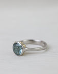 Silver ring with a blue stone on a white background