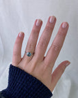 Silver ring with a blue gemstone on a hand