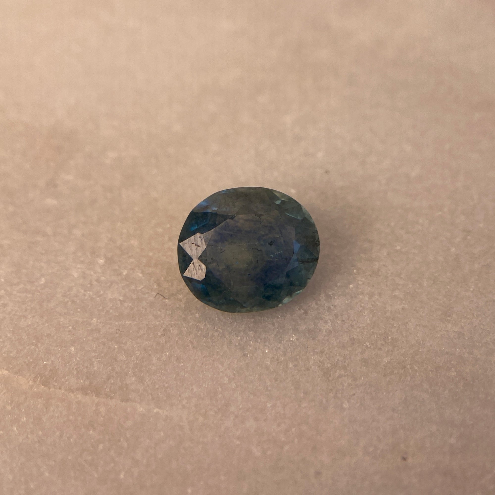 Small round object on a textured beige surface