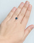 Round bright blue montana sapphire on hand 