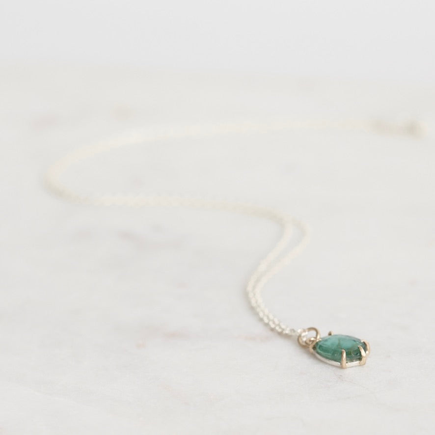 Necklace with a green pendant on a white background