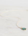 Necklace with a green pendant on a white background