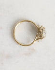 Gold ring with a diamond on a light marble background