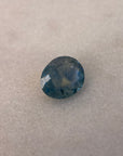 Blue gemstone on a textured beige background