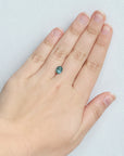 Blue sapphire with brown inclusion on hand