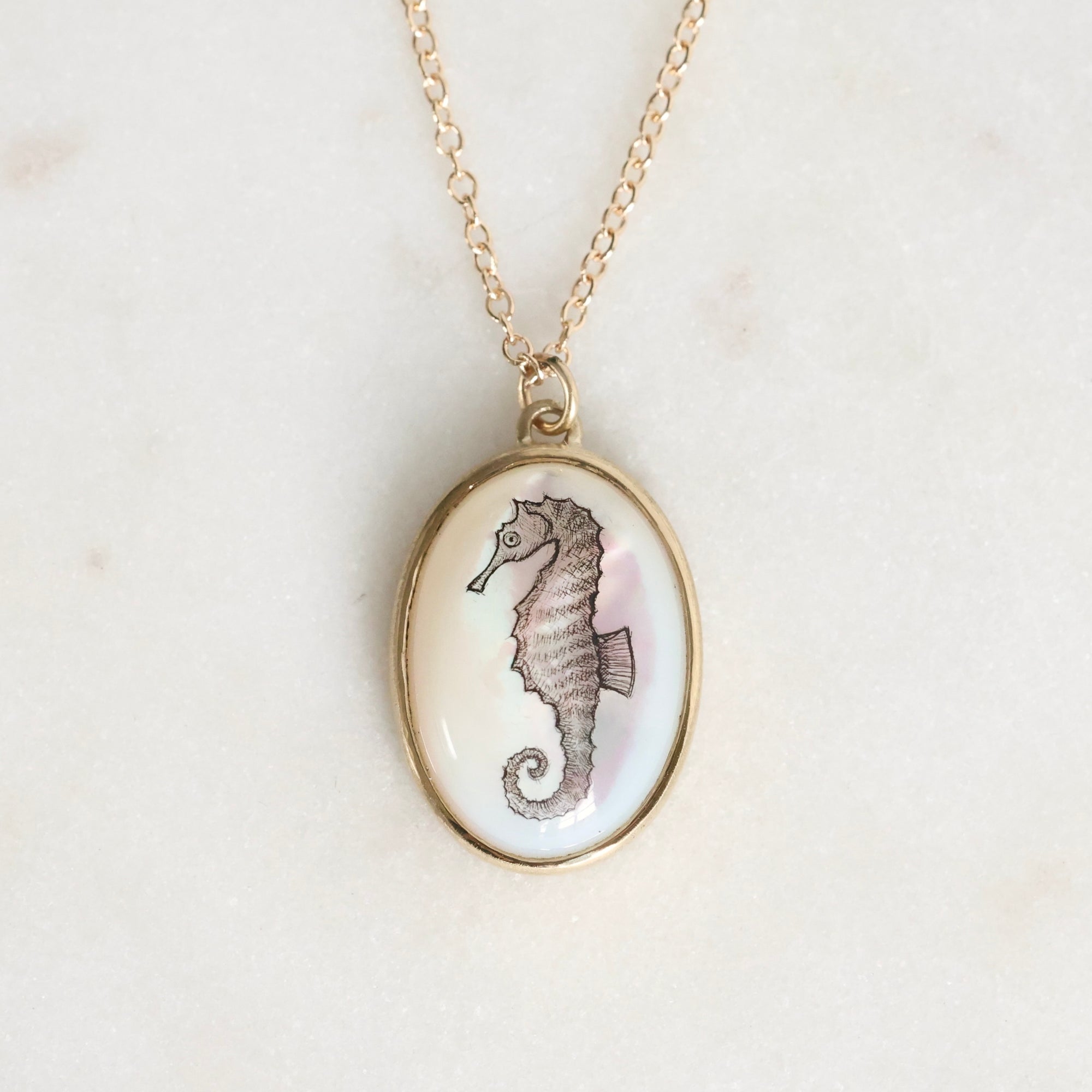 Necklace with a seahorse pendant on a light background