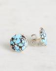 Turquoise stone stud earrings on a light gray background