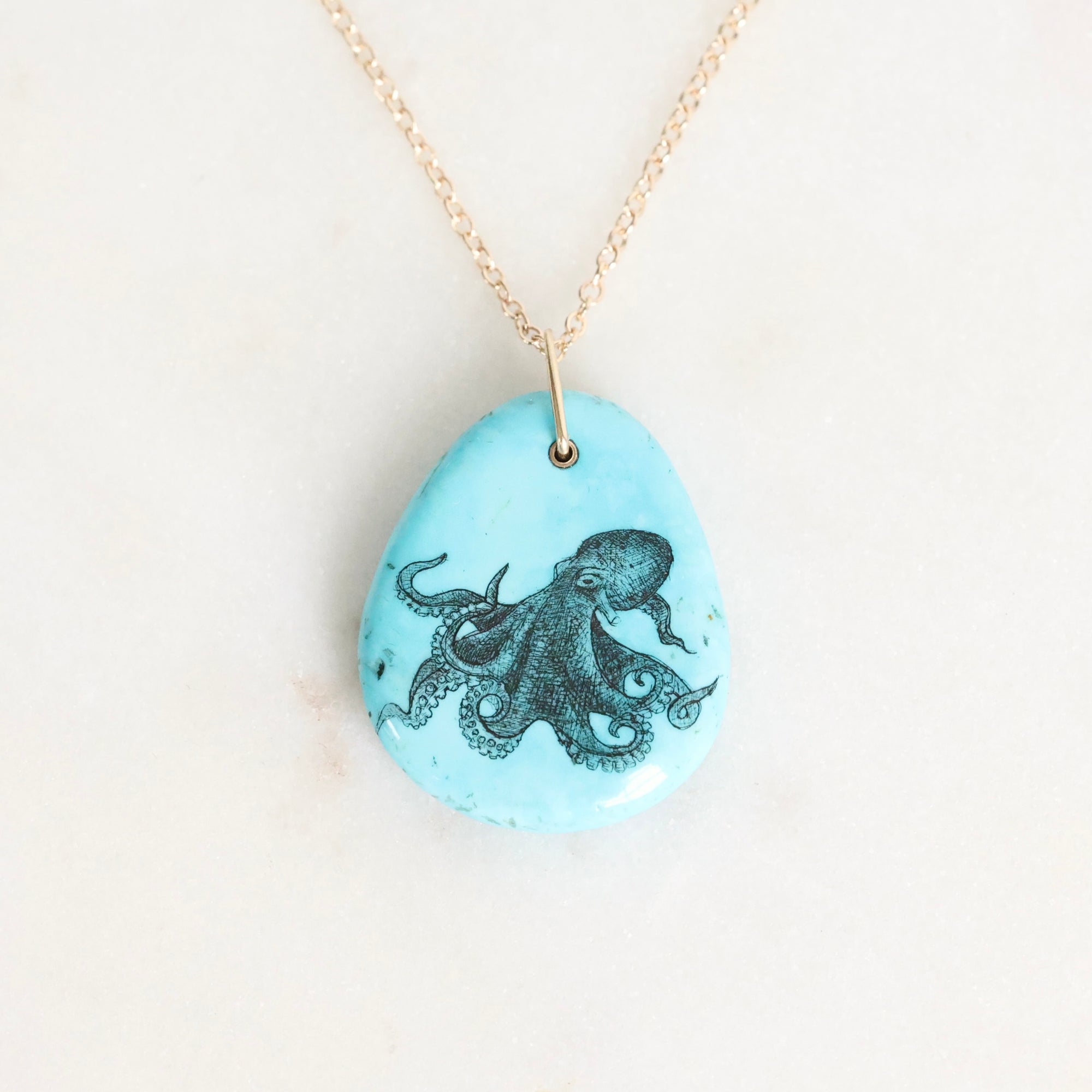 Necklace with a pendant featuring an octopus design on a light blue background