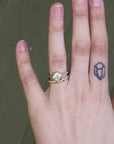 hand wearing diamond ring and wedding band