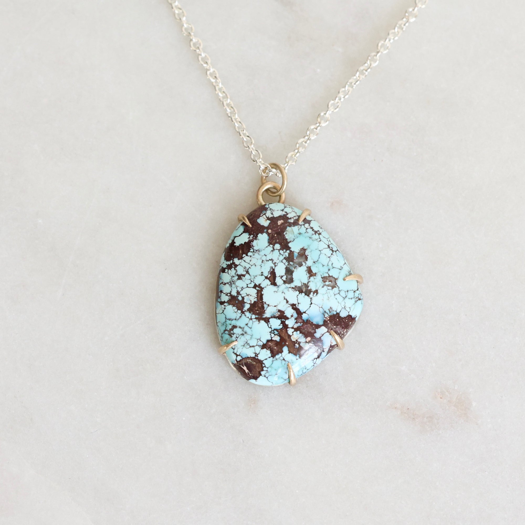 Turquoise stone necklace on a white background