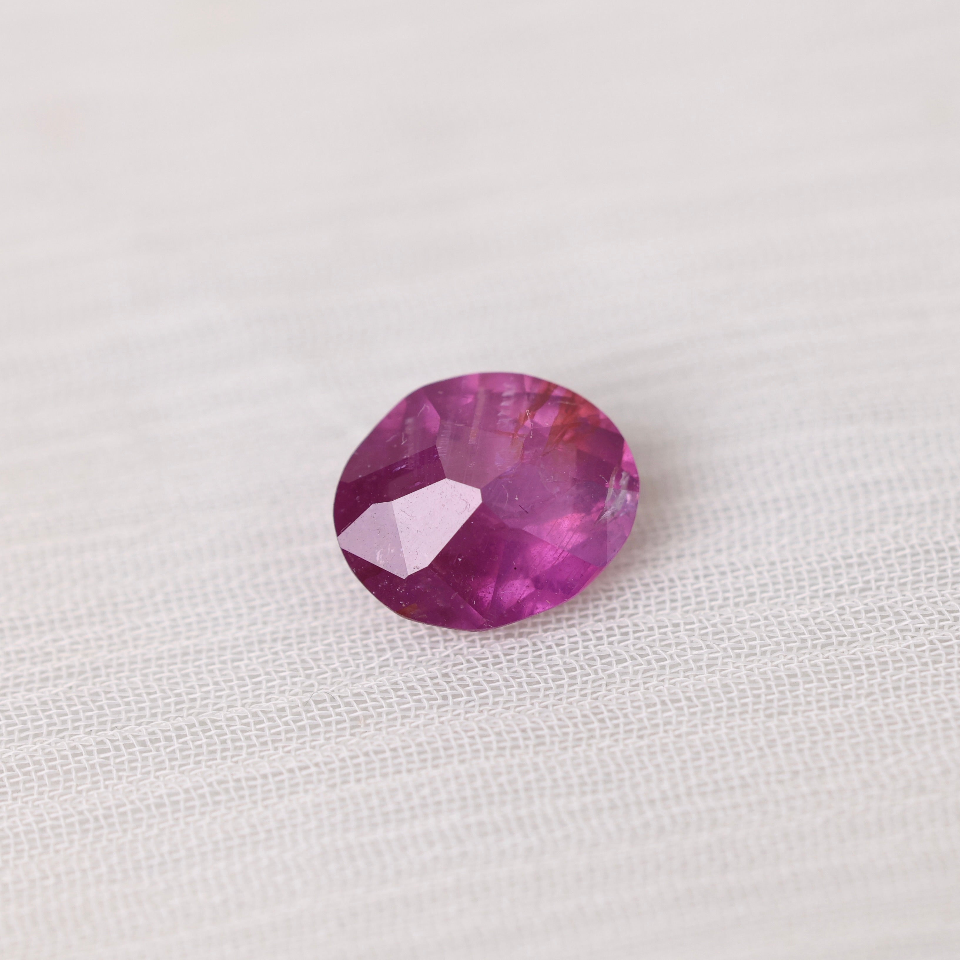 Purple stone on textured white background